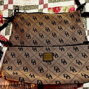 Dooney Burke purse. Does not have a strap as it frayed lined in red